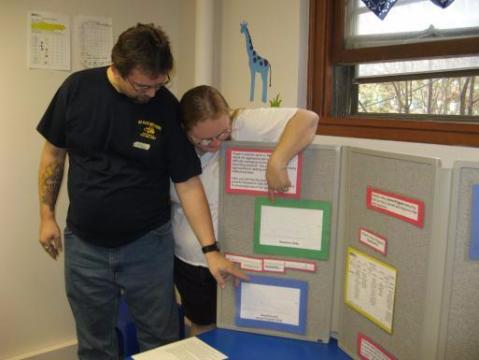 Kenny and Kim Petersen check out the charts marking their son's progress at home.